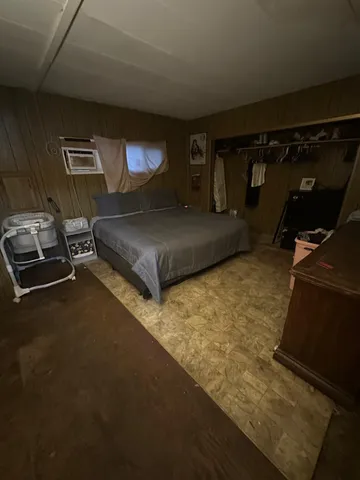 a bedroom with a bed and a tv