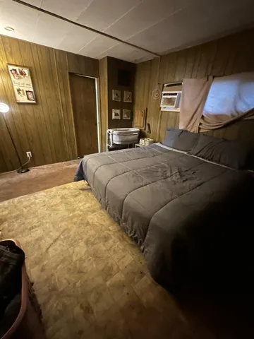 a bedroom with bed and window