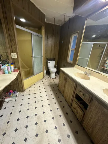 a bathroom with a sink a large mirror and a shower