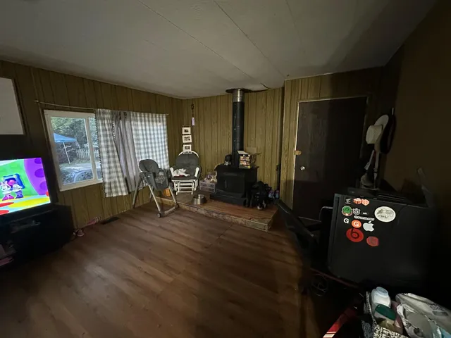 a living room with furniture and a floor to ceiling window