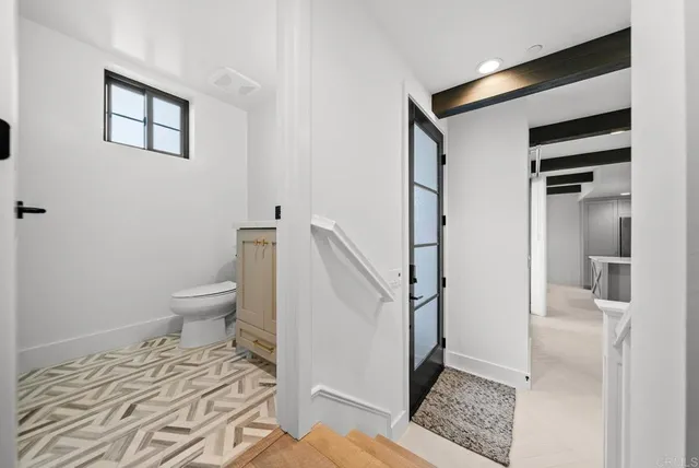 a bed sitting in a bedroom next to a window