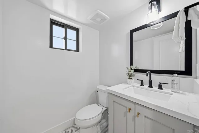 a bathroom with a double vanity sink mirror and