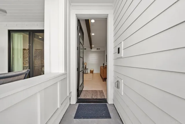 a view of hallway with wooden floor and stairs