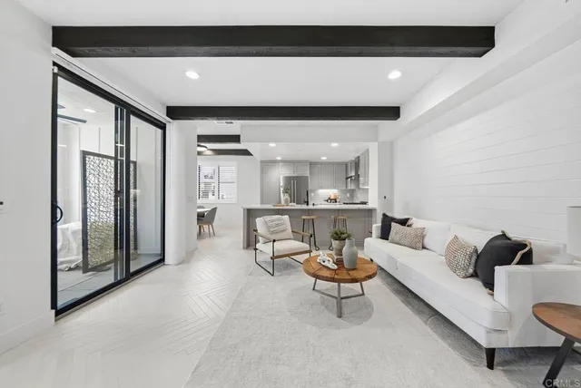 a kitchen with stainless steel appliances a sink a stove a refrigerator and cabinets