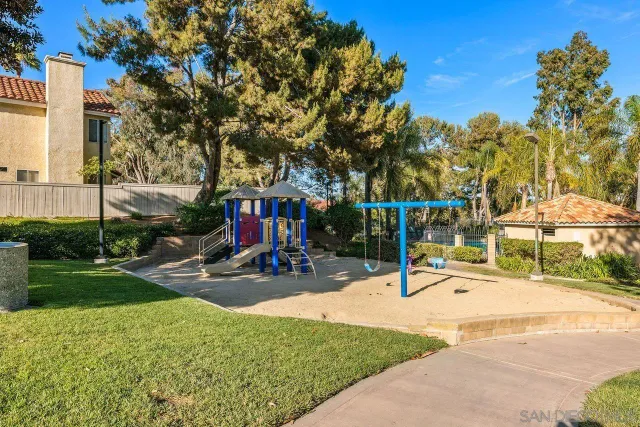 a view of a park with swings and slides