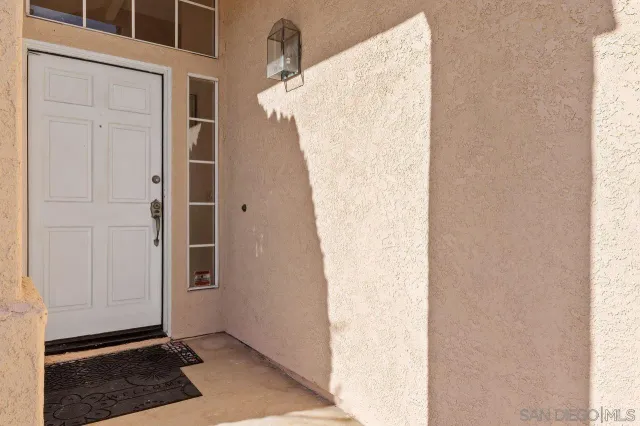 a living room with furniture and a baby crib
