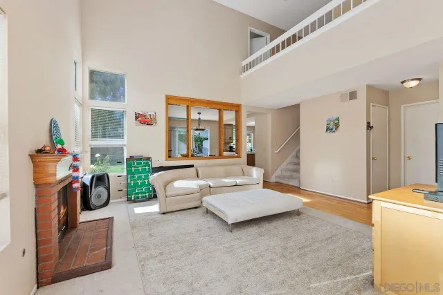 a living room with furniture a fireplace and flat screen tv