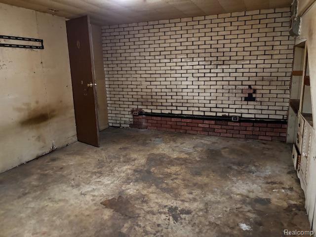 3901 West Lovejoy Road Byron, MI 48418 - Photo 12 of 19 Unfurnished room with concrete floors and brick wall