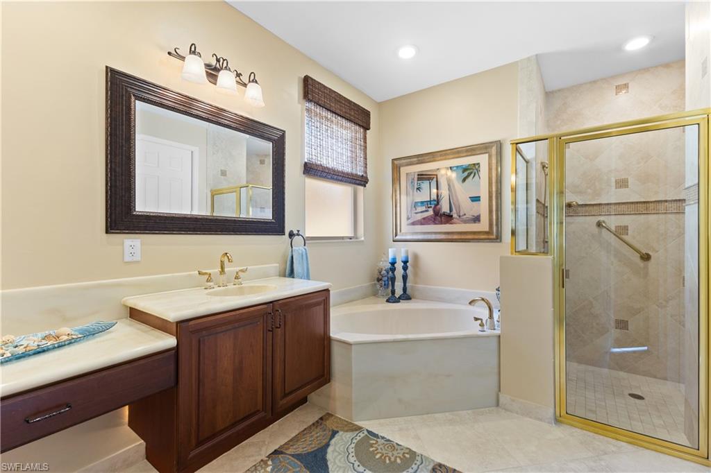 20398 Foxworth Circle Estero, FL 33928 - Photo 13 of 50 a bathroom with a double vanity sink mirror and bathtub