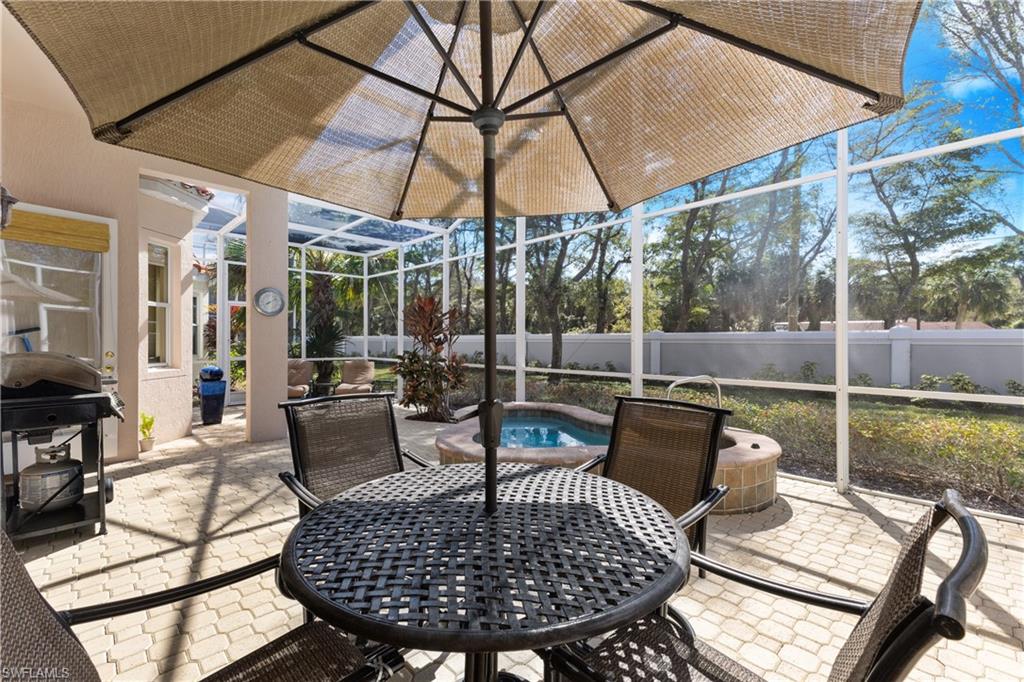 20398 Foxworth Circle Estero, FL 33928 - Photo 23 of 50 a view of a patio with couches chairs and a umbrella