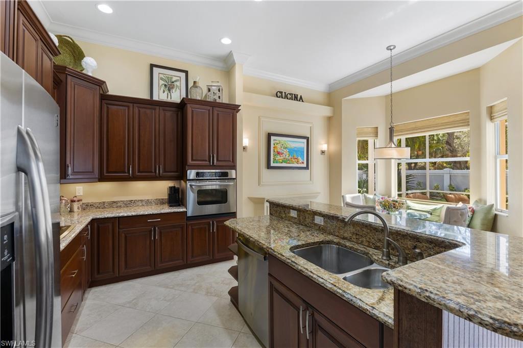 20398 Foxworth Circle Estero, FL 33928 - Photo 32 of 50 a kitchen that has a sink cabinets counter space and stainless steel appliances
