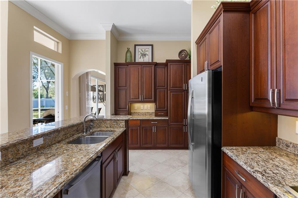 20398 Foxworth Circle Estero, FL 33928 - Photo 33 of 50 a kitchen with granite countertop a refrigerator and a sink