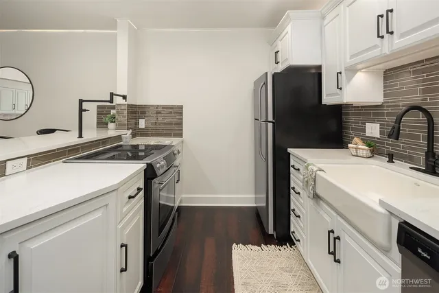 a kitchen with a refrigerator and a sink