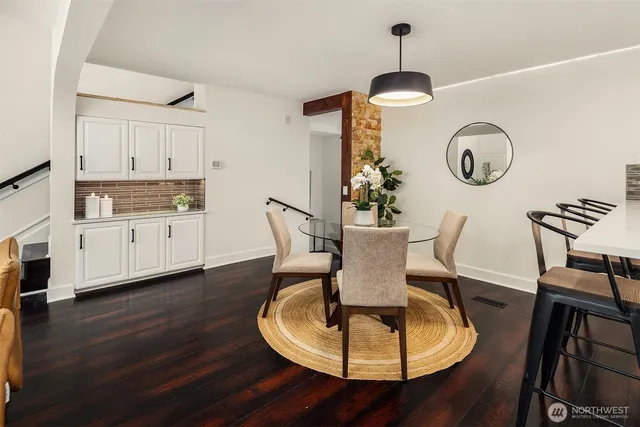 a dining room with furniture a chandelier and wooden floor