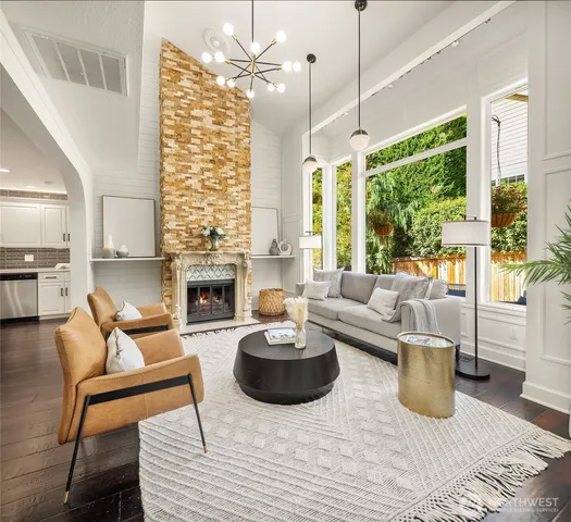 a living room with furniture a fireplace and a chandelier