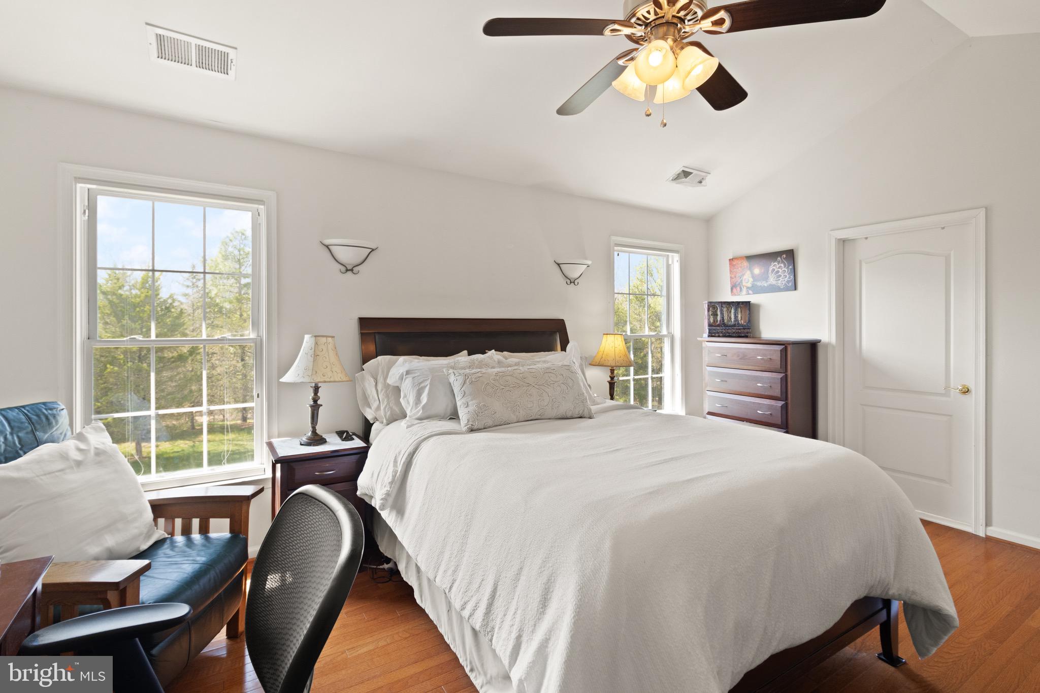 5652 Wheelwright Way Haymarket, VA 20169 - Photo 16 of 32 a bedroom with a bed and a chandelier