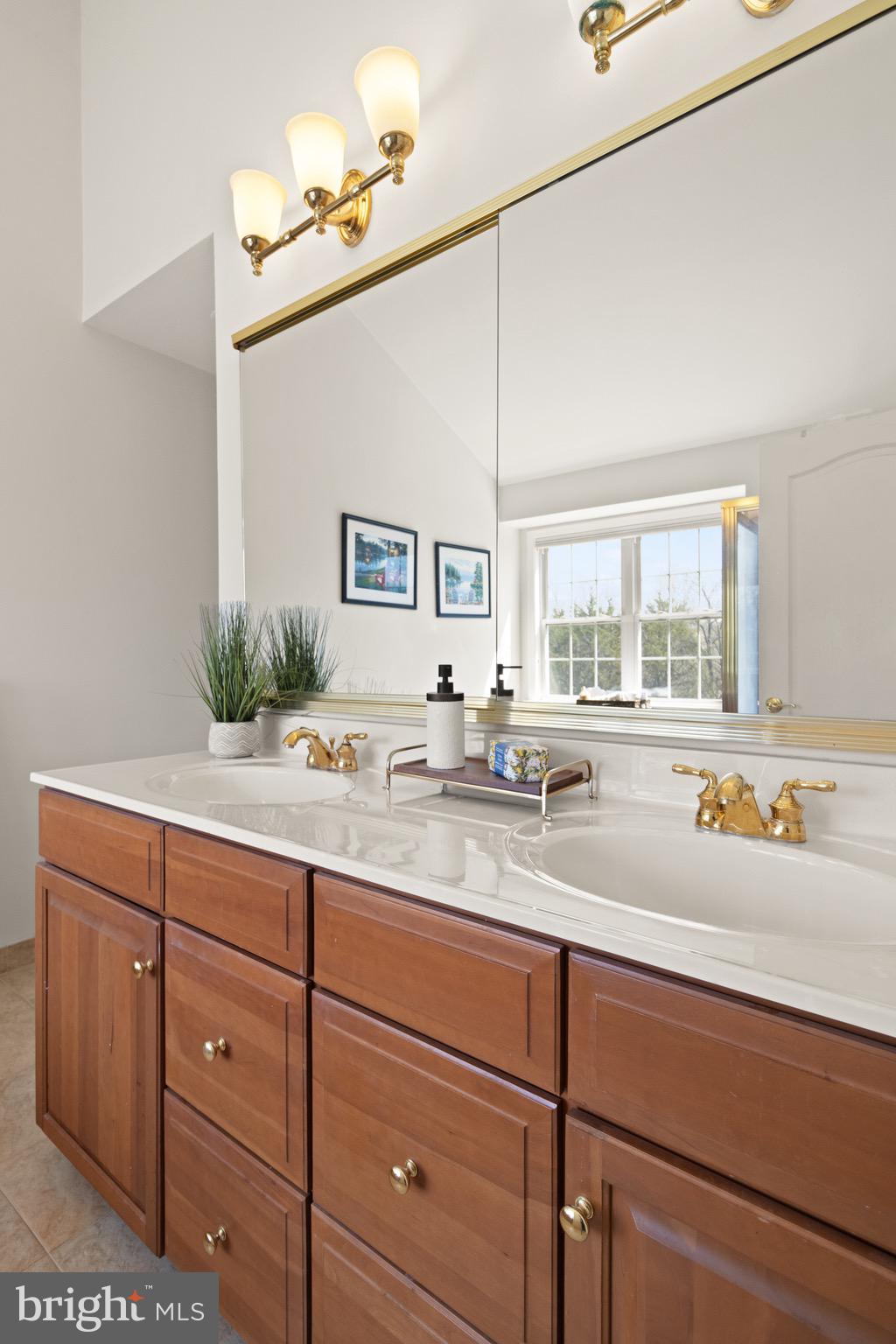 5652 Wheelwright Way Haymarket, VA 20169 - Photo 17 of 32 a bathroom with a granite countertop sink and a window