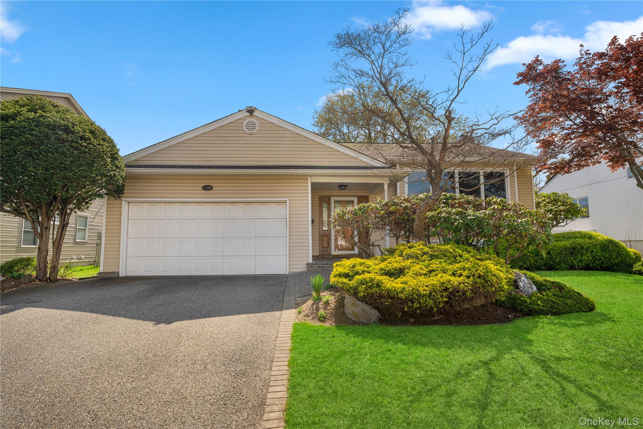 a front view of a house with garden