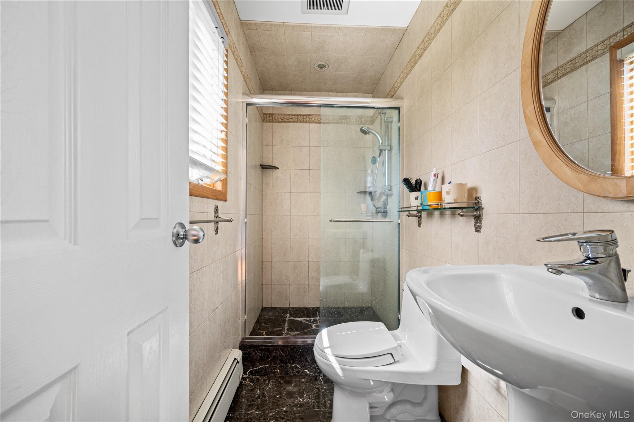 150 Roxton Road Plainview, NY 11803 - Photo 12 of 25 a bathroom with a sink toilet and shower