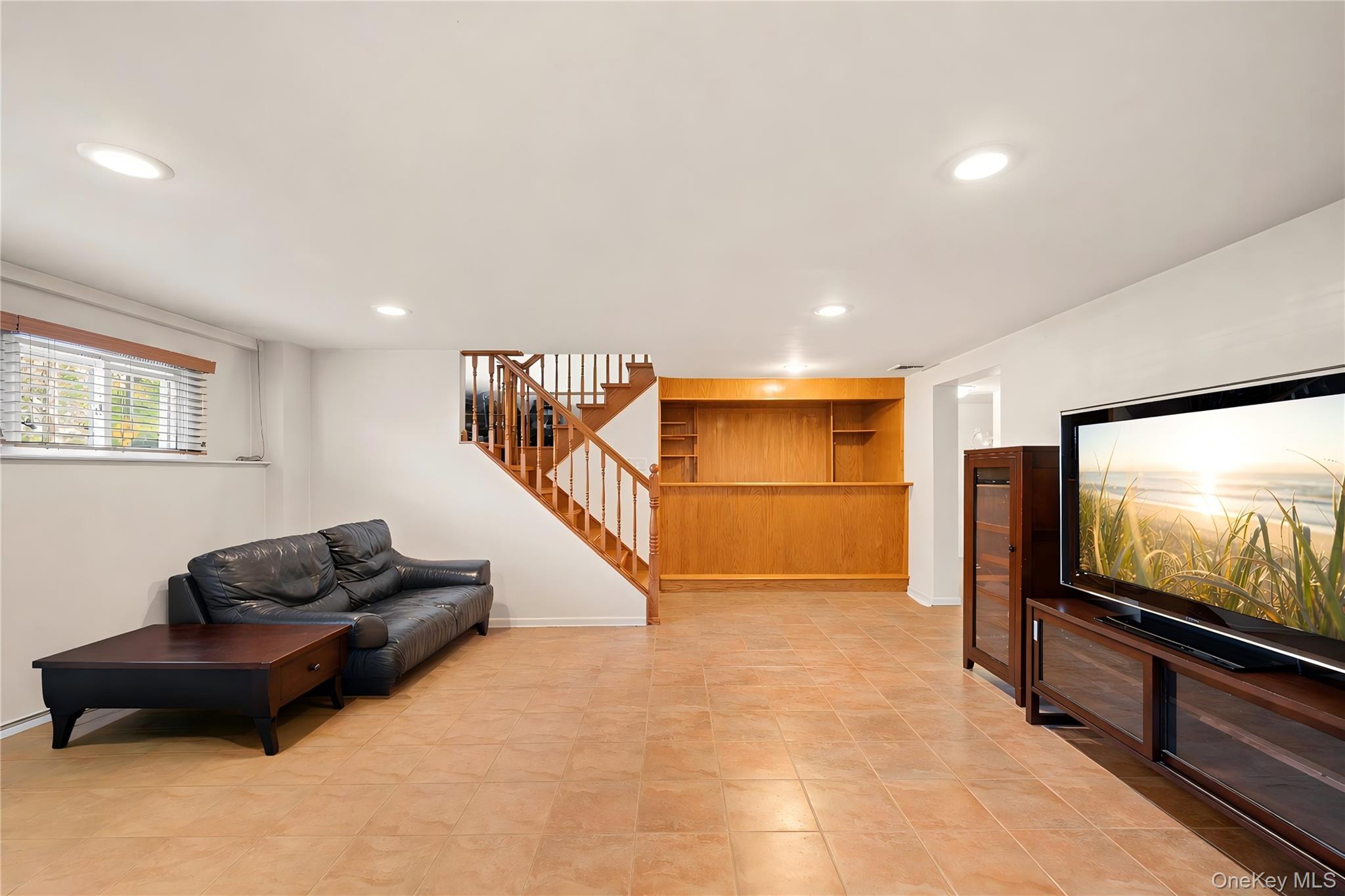 150 Roxton Road Plainview, NY 11803 - Photo 16 of 25 a living room with furniture and a flat screen tv