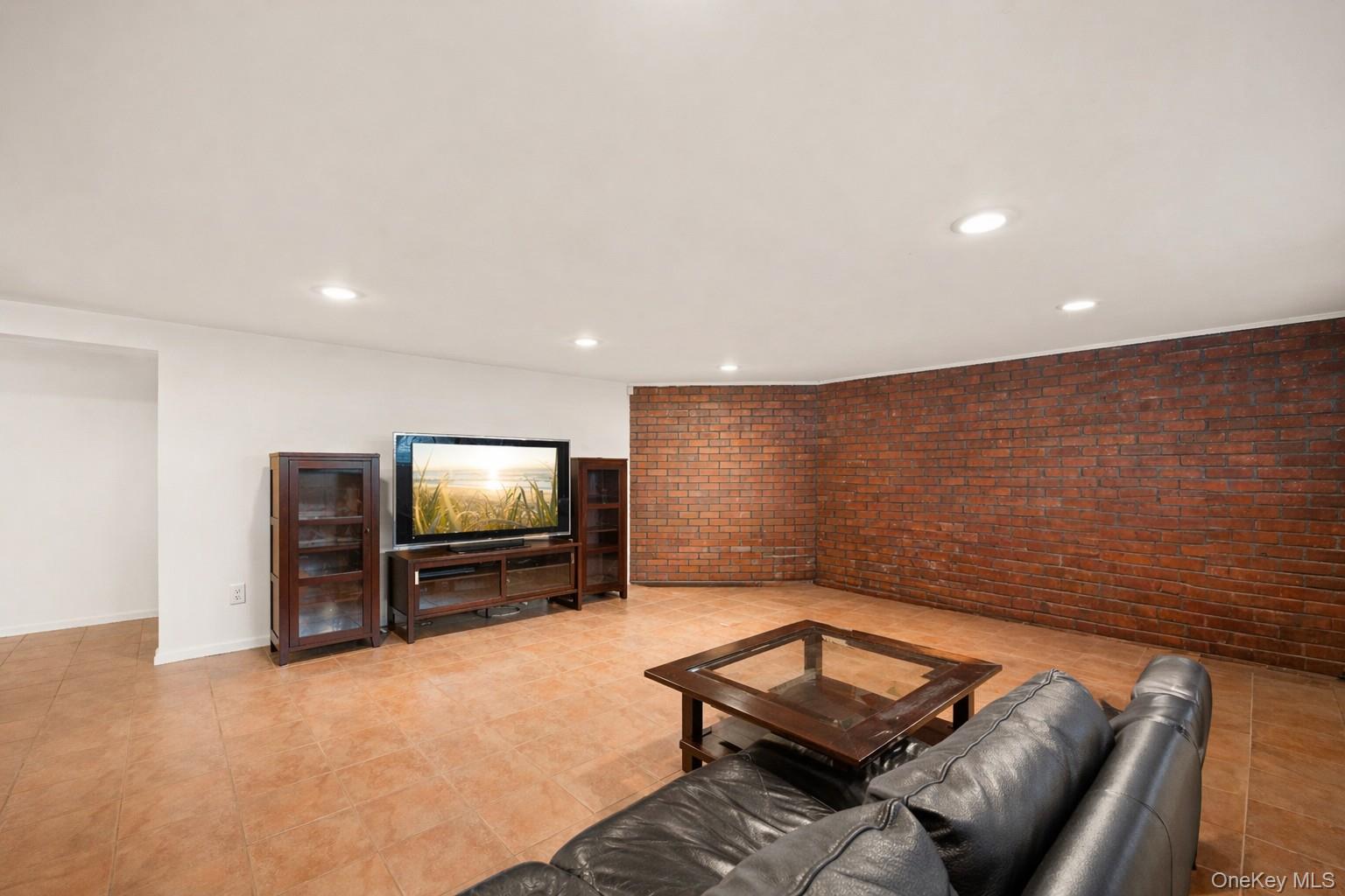 150 Roxton Road Plainview, NY 11803 - Photo 17 of 25 a living room with furniture and a flat screen tv