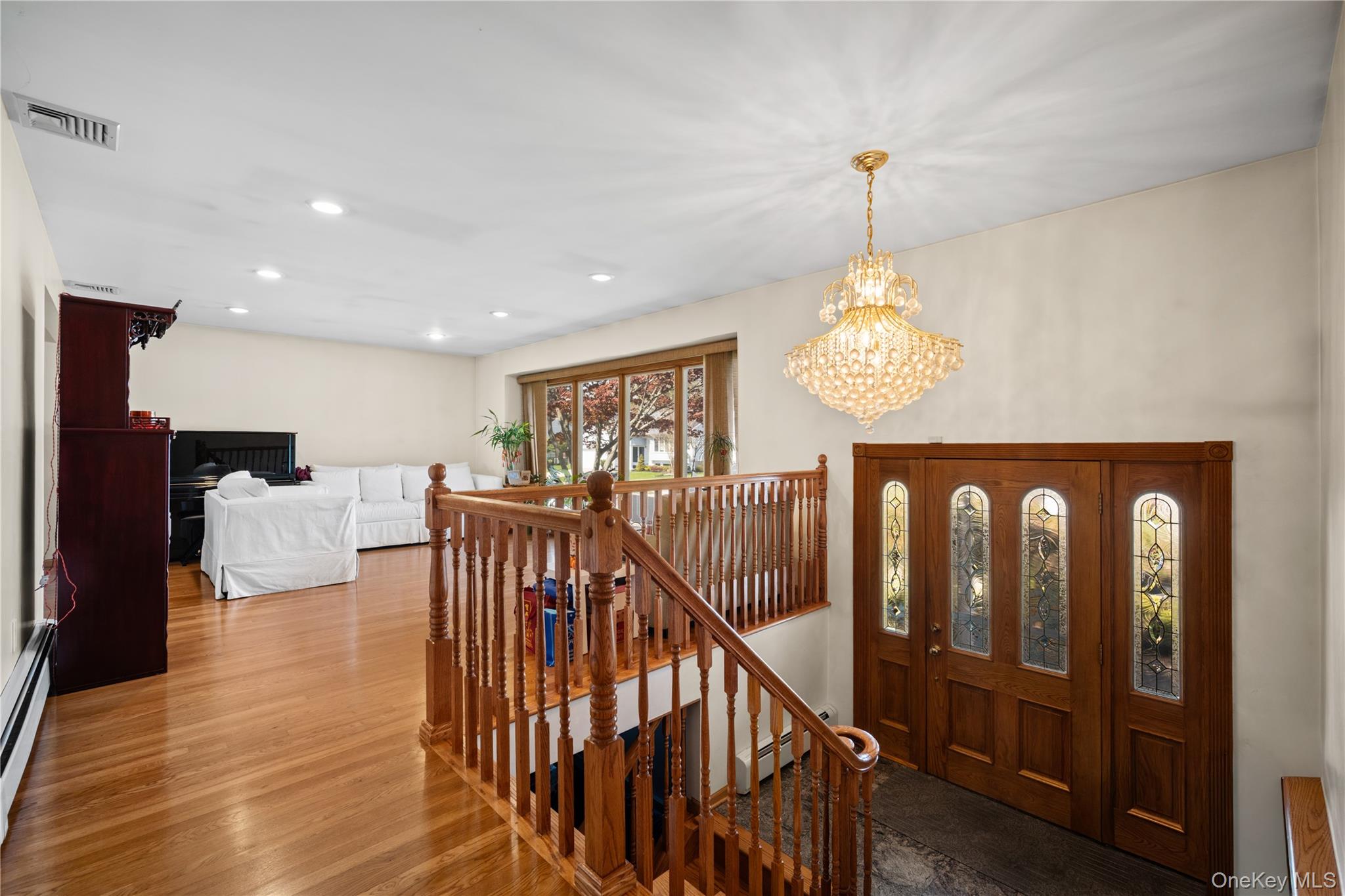150 Roxton Road Plainview, NY 11803 - Photo 3 of 25 a view of entryway dining room and hall with wooden floor