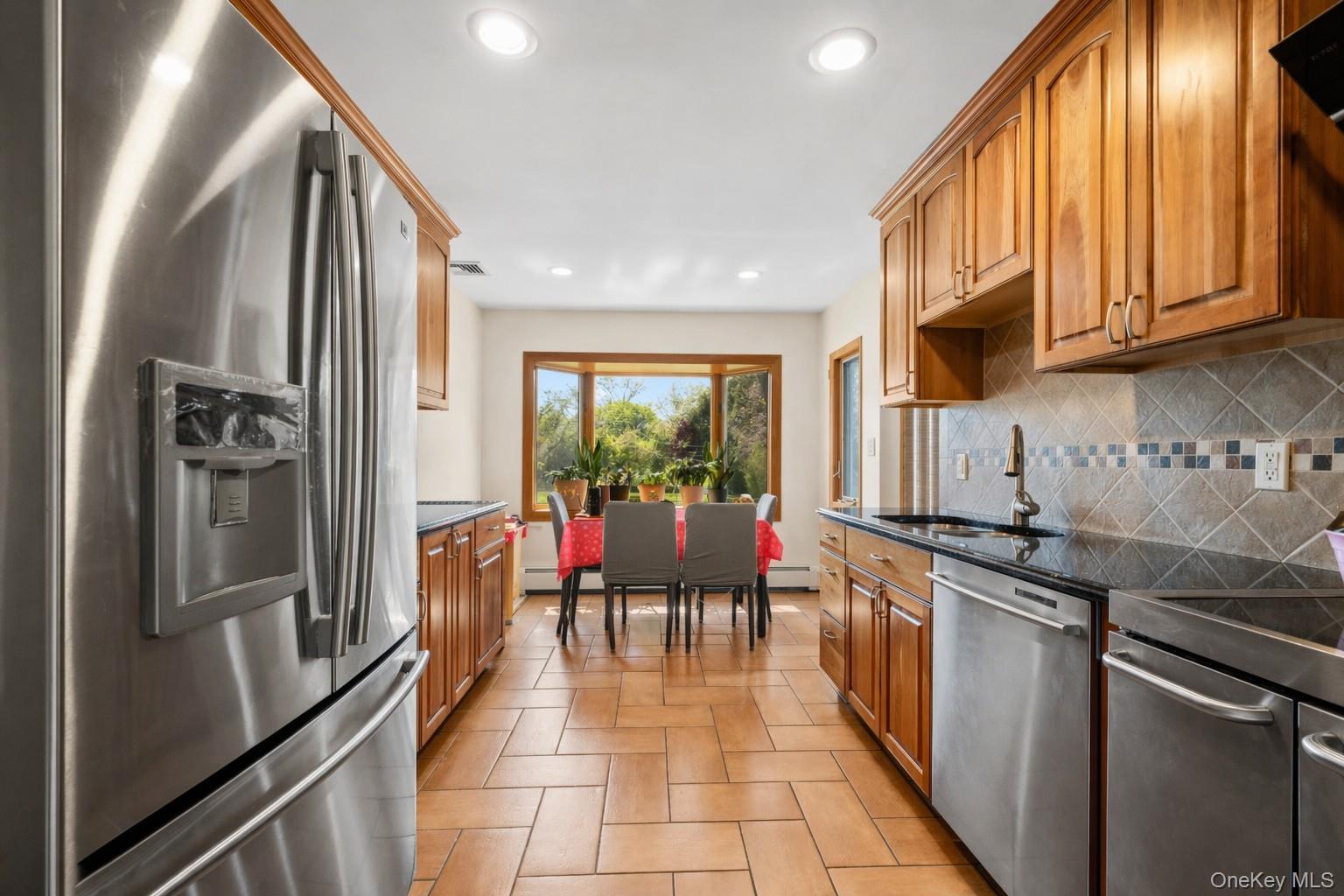 150 Roxton Road Plainview, NY 11803 - Photo 7 of 25 a kitchen with stainless steel appliances granite countertop a refrigerator and a stove
