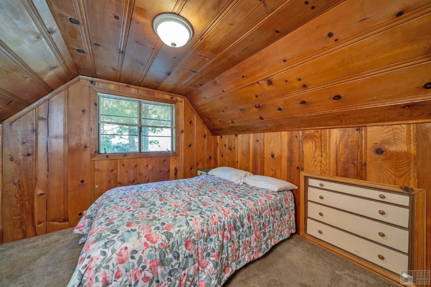 26 Sciots Tract Twin Bridges, CA 95735 - Photo 22 of 27 a bedroom with a bed and a dresser with wooden floor