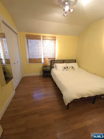 a bed sitting in a room next to a window