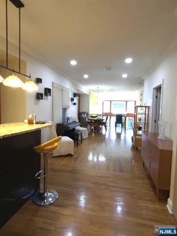 a living room with lots of furniture and kitchen view