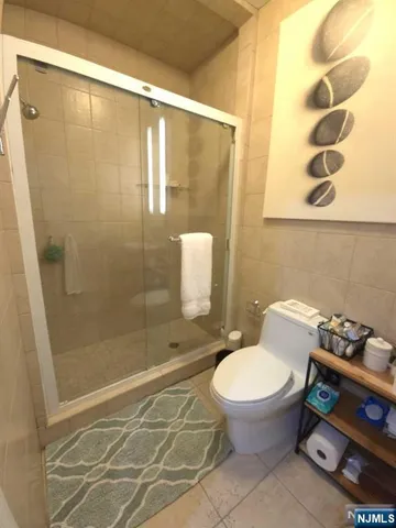 a bathroom with a toilet and a shower