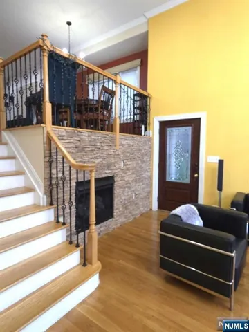 a living room with fireplace furniture and a ceiling fan