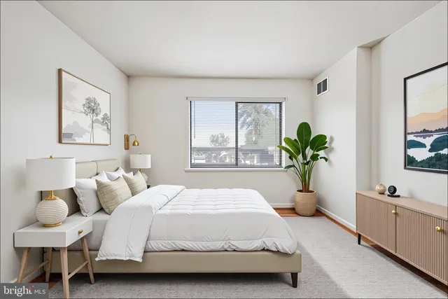 a spacious bedroom with a bed and a window