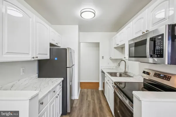 a kitchen with a sink a stove and refrigerator
