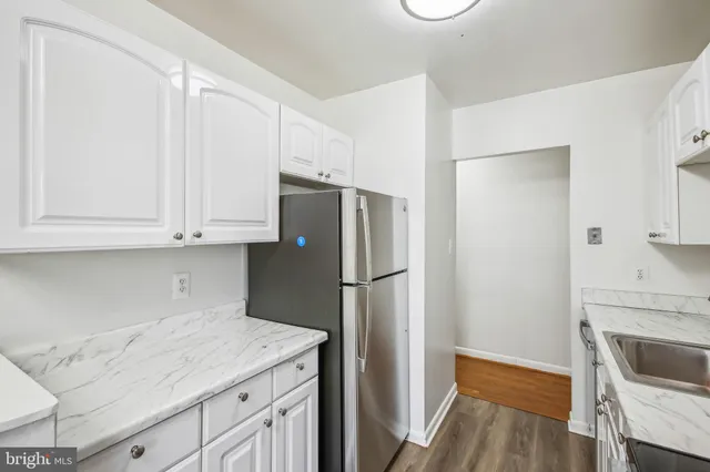 a kitchen with cabinets and stainless steel appliances