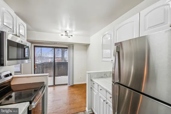a kitchen with stainless steel appliances a refrigerator and a stove top oven