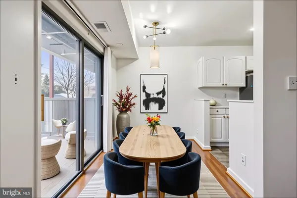 a dining room with furniture and wooden floor