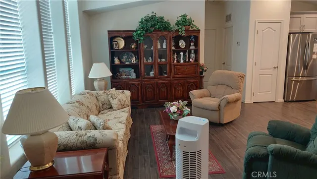 a kitchen with stainless steel appliances a refrigerator a sink a stove a table and chairs