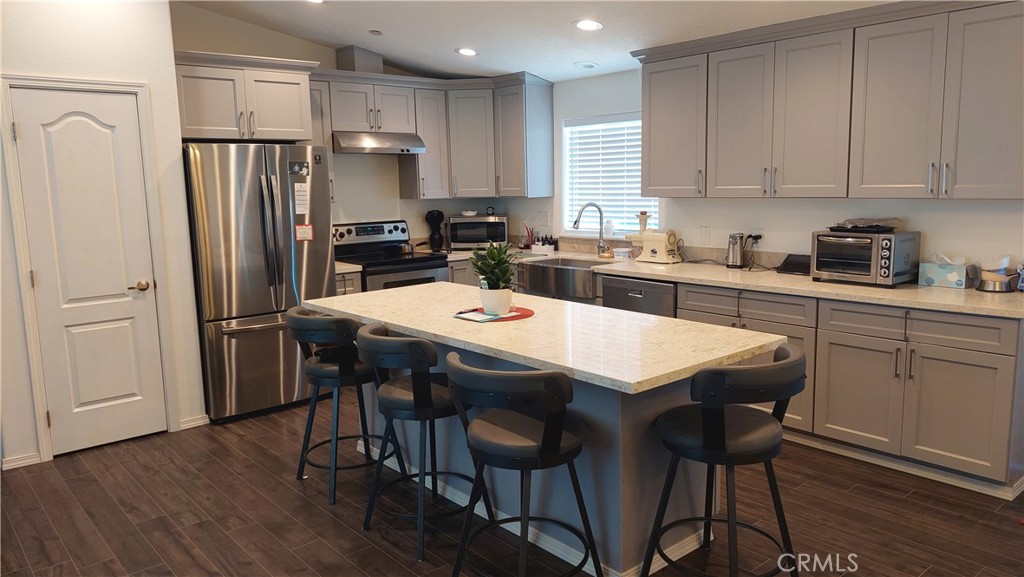 4250 Osborn Road Flournoy, CA 96021 - Photo 33 of 68 a kitchen with stainless steel appliances granite countertop a dining table chairs refrigerator and microwave