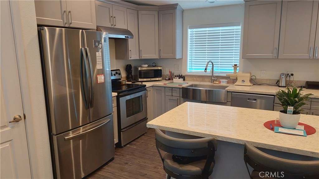 4250 Osborn Road Flournoy, CA 96021 - Photo 34 of 68 a kitchen with stainless steel appliances a refrigerator a sink a stove a table and chairs