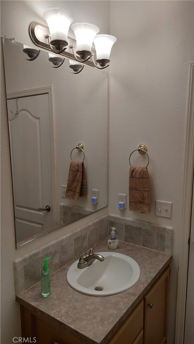 4250 Osborn Road Flournoy, CA 96021 - Photo 48 of 68 a bathroom with a sink and a mirror