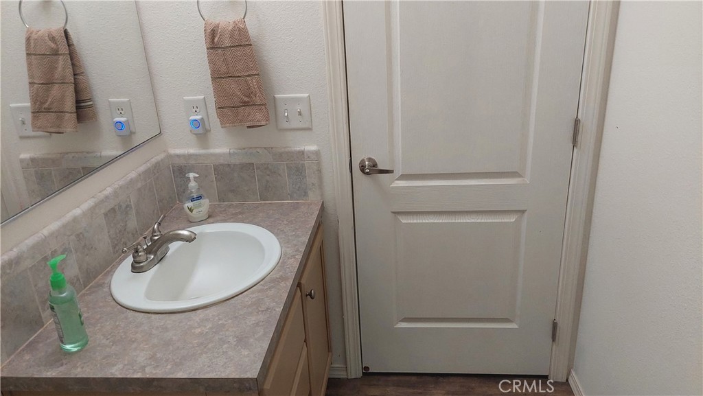 4250 Osborn Road Flournoy, CA 96021 - Photo 49 of 68 a bathroom with a granite countertop sink and a mirror