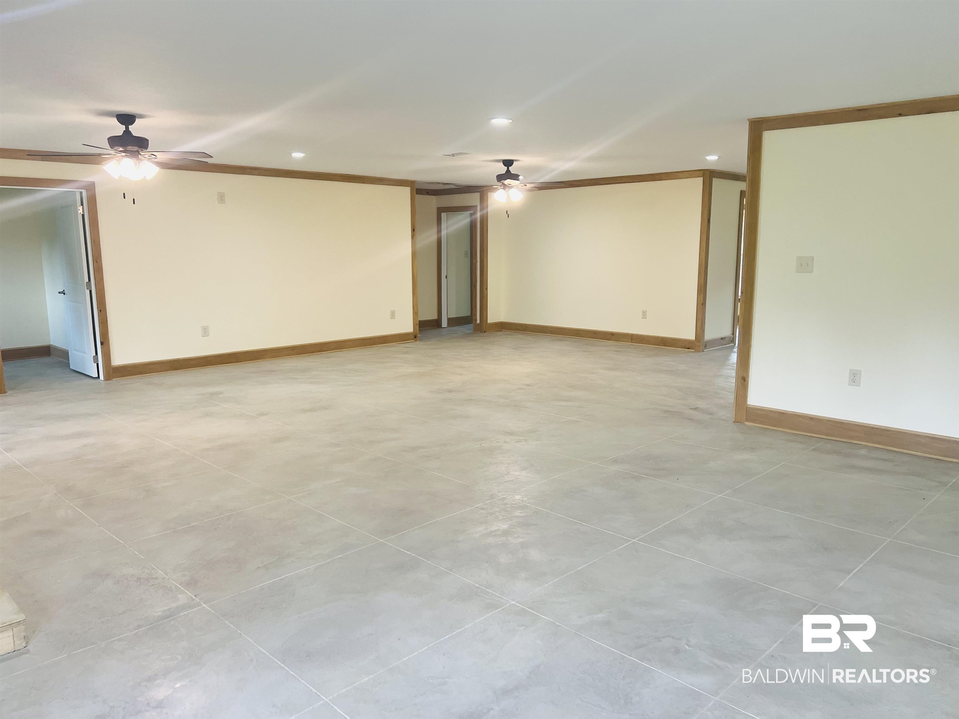 29685 Gardner Road Elberta, AL 36530 - Photo 4 of 16 Spacious interior with neutral-toned walls, wood-finish trim, and large format tile flooring