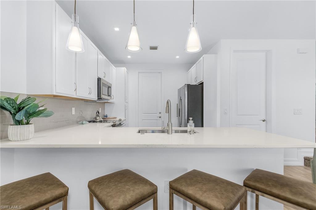 7596 Morgan Way Naples, FL 34119 - Photo 12 of 35 a kitchen with a table and chairs in it
