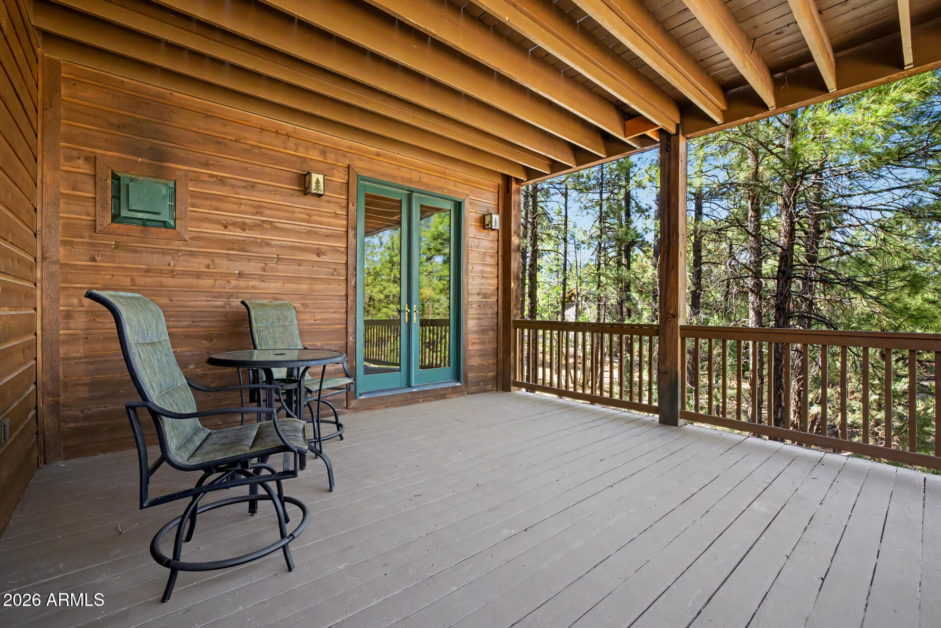 1681 South Jimson Loop Show Low, AZ 85901 - Photo 49 of 105 a view of a patio with table and chairs and wooden floor