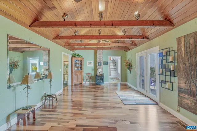 a view of a room with wooden floor