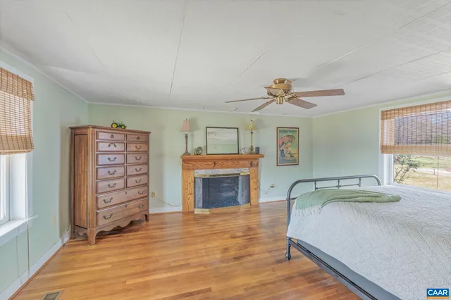 a bedroom with a bed and a fireplace