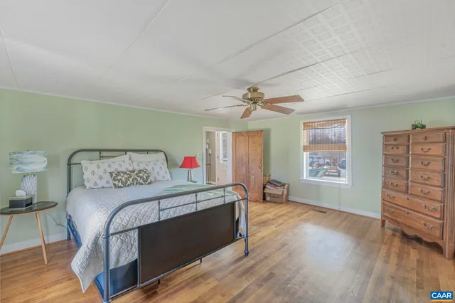 a bedroom with a bed and a dresser