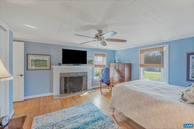 a spacious bedroom with a bed and a fireplace