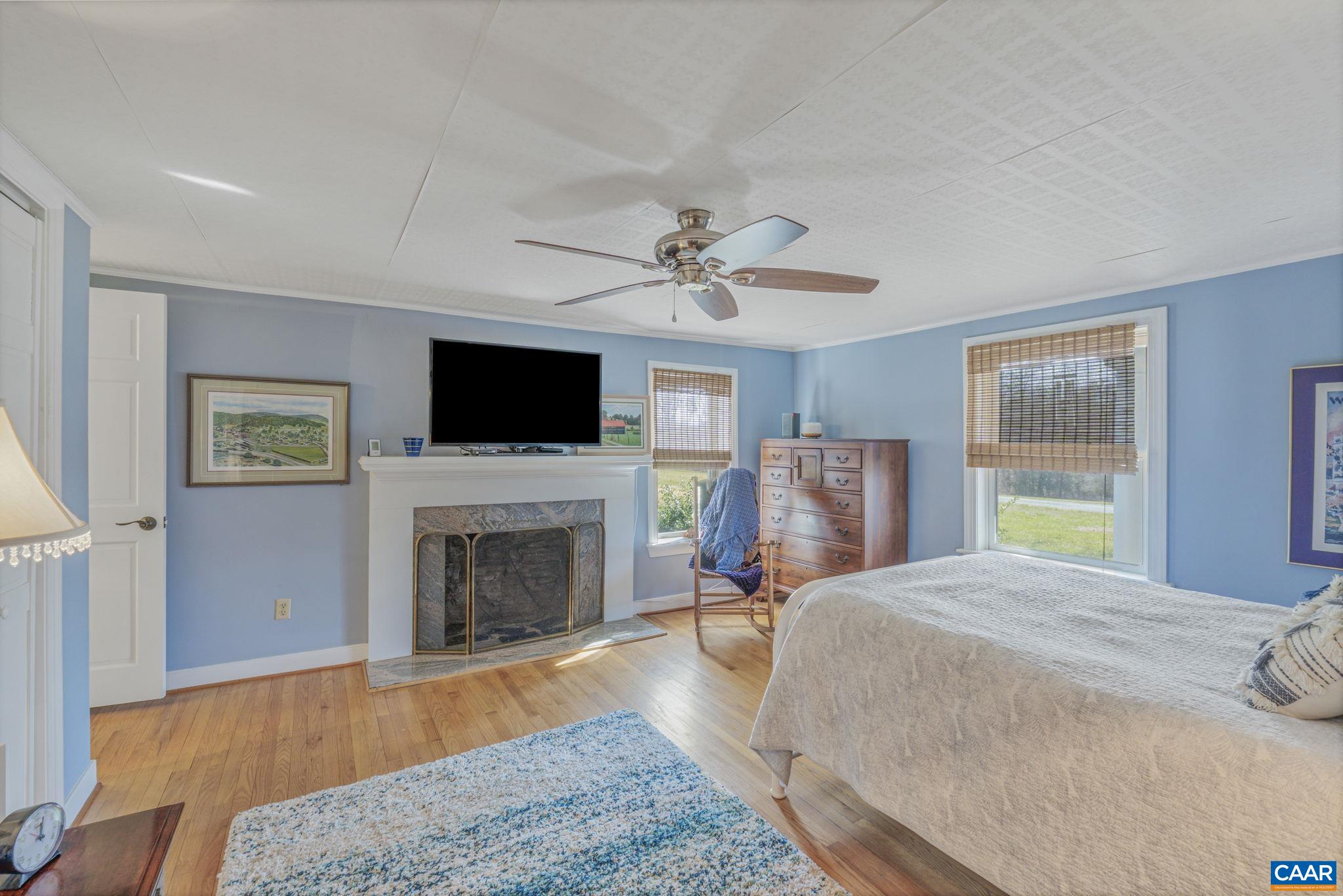 1353 Banton Shop Road Dillwyn, VA 23936 - Photo 15 of 57 a spacious bedroom with a bed and a fireplace